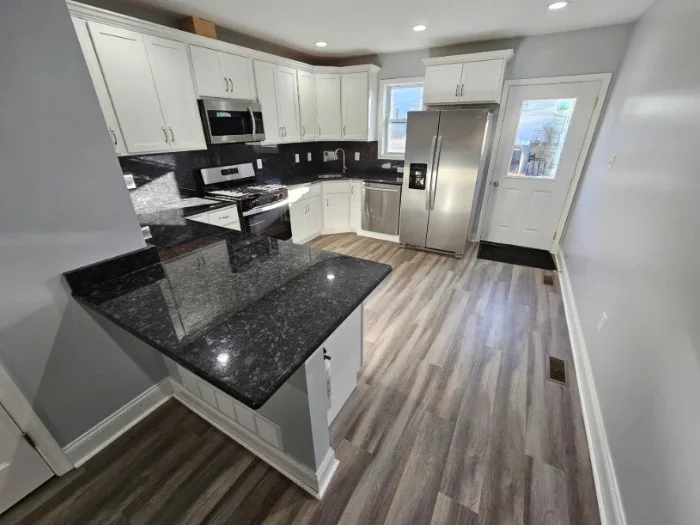 A residential kitchen with a fresh coat of light gray paint